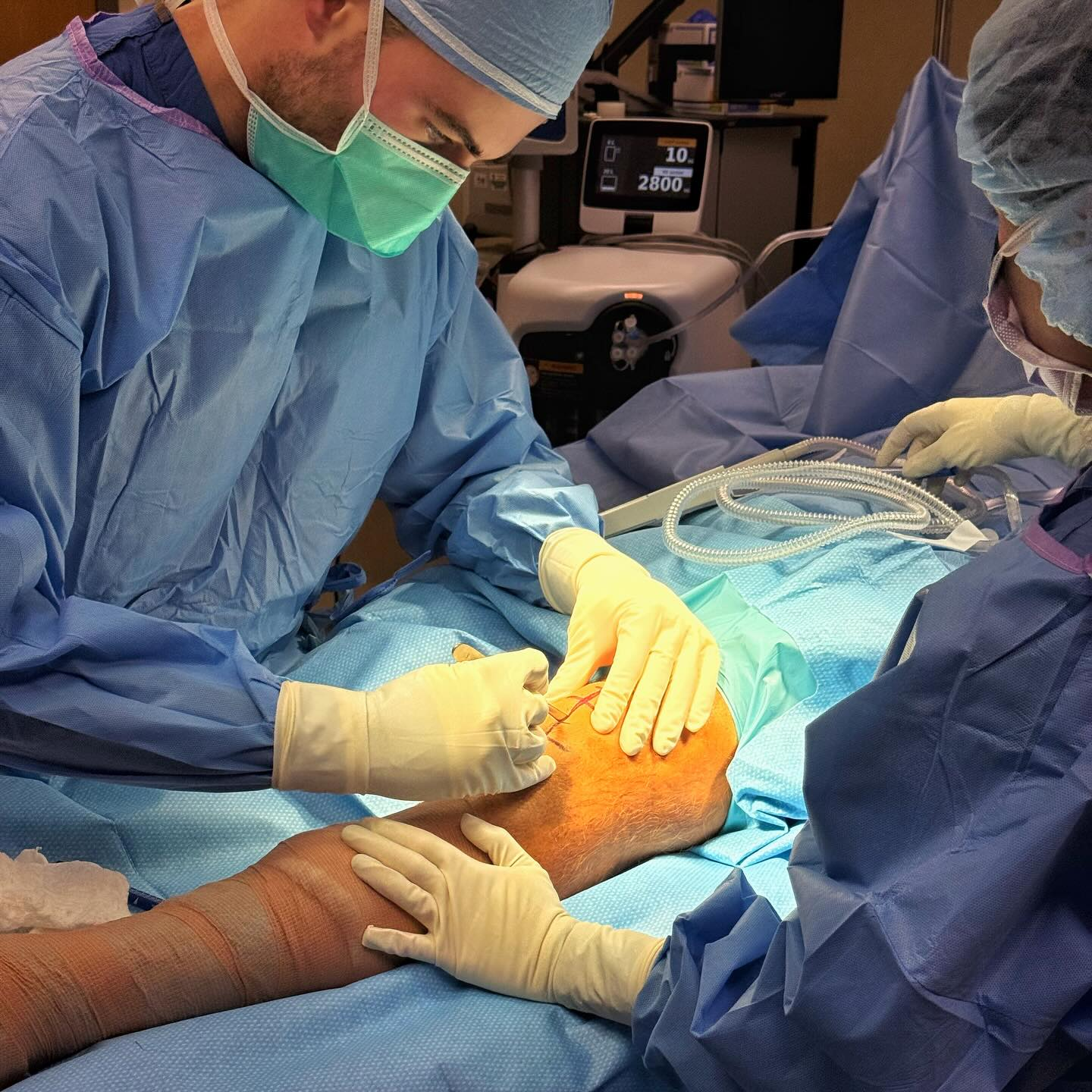 Dr. Nolan Horner reviewing a shoulder anatomical model